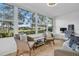 Bright sunroom with large windows offering a view of the landscaped backyard at 1227 Queen Anne Dr # C, Palm Harbor, FL 34684