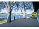 Large backyard deck with waterfront views and mature trees at 1514 Sea Gull S Dr, St Petersburg, FL 33707