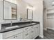 Bathroom with double vanity, modern fixtures, and gray countertop at 1514 Sea Gull S Dr, St Petersburg, FL 33707