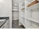 Bathroom with walk in closet and extra storage in shelving at 1514 Sea Gull S Dr, St Petersburg, FL 33707