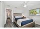 Bedroom with a neutral color scheme, ceiling fan, and light gray wood-look floors at 1514 Sea Gull S Dr, St Petersburg, FL 33707