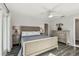 Bright bedroom with a ceiling fan, a light blue blanket and wood-look floors at 1514 Sea Gull S Dr, St Petersburg, FL 33707