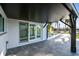 Covered patio featuring slate pavers, with a view of the pool and a waterfront view at 1514 Sea Gull S Dr, St Petersburg, FL 33707