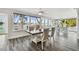 Waterfront dining room features luxury vinyl plank flooring and large windows with serene canal view at 1514 Sea Gull S Dr, St Petersburg, FL 33707