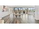 Bright dining room featuring tile floors and floor-to-ceiling glass doors offering serene water views at 1514 Sea Gull S Dr, St Petersburg, FL 33707