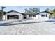 Charming single-story home with black trim, a two-car garage, and modern curb appeal at 1514 Sea Gull S Dr, St Petersburg, FL 33707