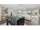 Foosball table area with natural light and view to the living room, kitchen and water views at 1514 Sea Gull S Dr, St Petersburg, FL 33707