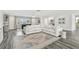 Bright and airy living room with views of the backyard, a foosball table, and plank floors at 1514 Sea Gull S Dr, St Petersburg, FL 33707
