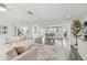 Open living room featuring wood floors, water views, and a comfortable sofa at 1514 Sea Gull S Dr, St Petersburg, FL 33707