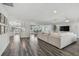 Spacious living room with plank floors that transitions to the dining area and kitchen at 1514 Sea Gull S Dr, St Petersburg, FL 33707