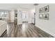 Inviting living room with tile plank floors, shelving, and entryway with front door at 1514 Sea Gull S Dr, St Petersburg, FL 33707