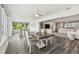 Open floor plan showcasing luxury vinyl flooring, living room, dining space, and sunroom at 1514 Sea Gull S Dr, St Petersburg, FL 33707