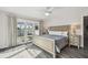 Main bedroom featuring a king-size bed, waterfront view, and access to patio at 1514 Sea Gull S Dr, St Petersburg, FL 33707