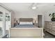 Main bedroom with neutral colors, tiled floors, and matching nightstands at 1514 Sea Gull S Dr, St Petersburg, FL 33707
