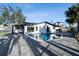 Backyard view of in-ground pool featuring a covered patio and beautiful pavers, with a waterfront view at 1514 Sea Gull S Dr, St Petersburg, FL 33707