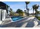 Private backyard oasis with a sparkling in-ground pool, surrounded by lush palm trees at 1514 Sea Gull S Dr, St Petersburg, FL 33707