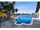 Private pool overlooking waterfront with lush tropical landscaping on a sunny day at 1514 Sea Gull S Dr, St Petersburg, FL 33707