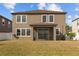 Back of the home featuring a lawn, screened in patio, and a traditional build style at 19429 Paddock View Dr, Tampa, FL 33647