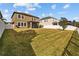 The backyard is fenced, with a large grassy lawn and a screened porch in the background at 19429 Paddock View Dr, Tampa, FL 33647