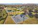 An aerial shot reveals the basketball court, tennis court, and community pool in a scenic residential area at 19429 Paddock View Dr, Tampa, FL 33647