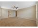 Large bedroom with neutral carpet, ceiling fan, and en-suite bathroom access at 19429 Paddock View Dr, Tampa, FL 33647