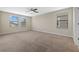 Spacious bedroom with neutral carpet, large windows, and great natural lighting at 19429 Paddock View Dr, Tampa, FL 33647