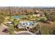 Aerial view of Heron Preserve community pool, tennis court, playground, and clubhouse at 19429 Paddock View Dr, Tampa, FL 33647
