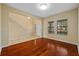 Bright foyer featuring hardwood floors, stairs with white railings and natural light from the windows at 19429 Paddock View Dr, Tampa, FL 33647
