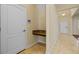 Hallway featuring neutral colors, tile flooring, and granite countertop desk area at 19429 Paddock View Dr, Tampa, FL 33647