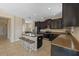 Gourmet kitchen features granite countertops, dark cabinets, island seating, and stainless appliances at 19429 Paddock View Dr, Tampa, FL 33647