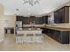 Spacious kitchen featuring dark wood cabinets, stainless steel appliances and an island with seating at 19429 Paddock View Dr, Tampa, FL 33647