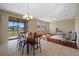 Open-concept living and dining area with tile and wood floors, and sliding doors to the exterior at 19429 Paddock View Dr, Tampa, FL 33647