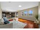 Open-concept living room with wood floors, large windows, and seamless access to kitchen and dining at 19429 Paddock View Dr, Tampa, FL 33647