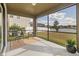 Cozy screened porch with lovely views of a green lawn and tranquil pond at 19429 Paddock View Dr, Tampa, FL 33647