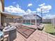 Backyard view of a screened pool with brick-paved patio, providing a private and relaxing outdoor space at 2020 Cattleman Dr, Brandon, FL 33511