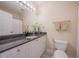 Classic bathroom showcasing a granite countertop, white vanity, and traditional fixtures at 3410 Sondrio Cir, Tampa, FL 33611