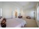 Large bedroom featuring tray ceilings, neutral carpet, and many windows at 3410 Sondrio Cir, Tampa, FL 33611
