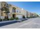 Multi-level townhome shows well with attached garages, neutral color scheme, and tropical landscaping at 3410 Sondrio Cir, Tampa, FL 33611