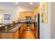Bright kitchen features stainless steel appliances, wood cabinets, and a breakfast bar at 3410 Sondrio Cir, Tampa, FL 33611