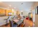 Open-concept living room with a breakfast bar, dining table, and hardwood floors at 3410 Sondrio Cir, Tampa, FL 33611