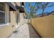 Private patio featuring brick pavers, black awnings, a white privacy gate and mature palm trees at 3410 Sondrio Cir, Tampa, FL 33611
