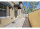 Home exterior featuring a private fenced patio with brick pavers and awnings over the windows at 3410 Sondrio Cir, Tampa, FL 33611