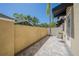 Private home patio featuring brick pavers, black awnings, privacy wall and view of the palms at 3410 Sondrio Cir, Tampa, FL 33611