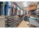Organized walk-in closet featuring ample hanging space and storage drawers for clothes and accessories at 3410 Sondrio Cir, Tampa, FL 33611