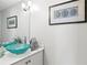 Elegant bathroom featuring double sinks with decorative glass bowls and a modern vanity at 4810 W San Miguel St, Tampa, FL 33629
