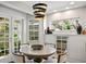 Charming dining area boasting a modern chandelier, built-in cabinets, and views of the landscaped yard at 4810 W San Miguel St, Tampa, FL 33629