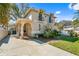 Charming two-story home featuring lush landscaping, an arched entryway, and a well-maintained lawn at 4810 W San Miguel St, Tampa, FL 33629