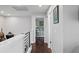Bright hallway featuring hardwood floors and an open doorway into the bedroom at 4810 W San Miguel St, Tampa, FL 33629