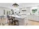 Bright kitchen features a large island with quartz countertops, stainless steel appliances, and designer backsplash at 4810 W San Miguel St, Tampa, FL 33629