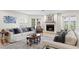 Cozy living room featuring a fireplace, comfortable seating, and lots of natural light from a window and French doors at 4810 W San Miguel St, Tampa, FL 33629